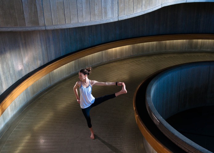 conceptual photography - women practice relaxing yoga in the train station